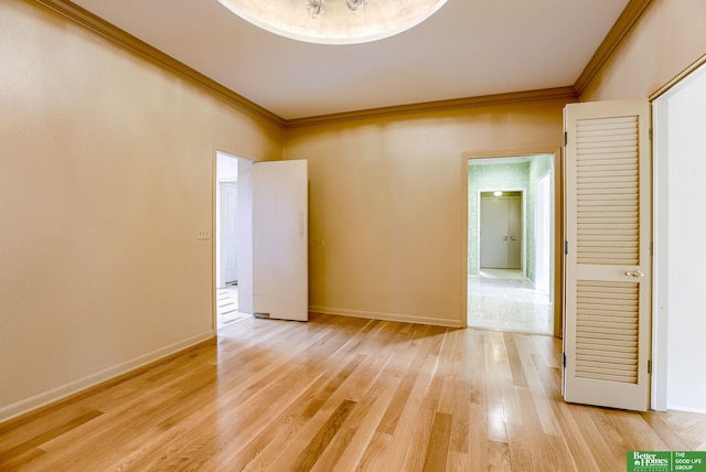 unfurnished room with crown molding and light hardwood / wood-style floors