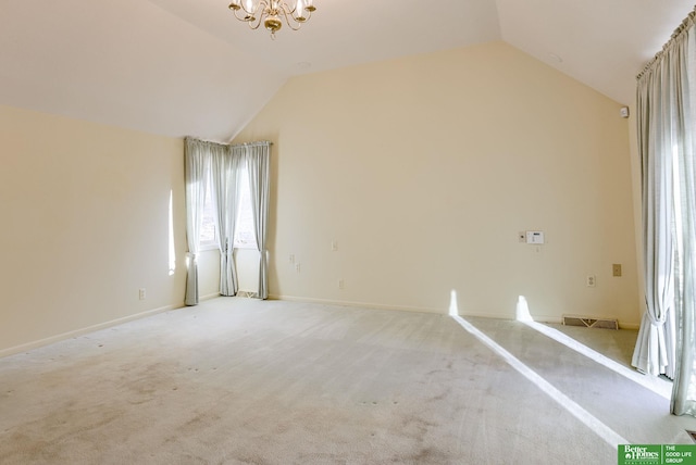 carpeted empty room featuring lofted ceiling and a notable chandelier