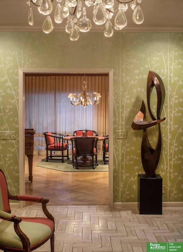 dining room featuring crown molding, light parquet flooring, and a chandelier