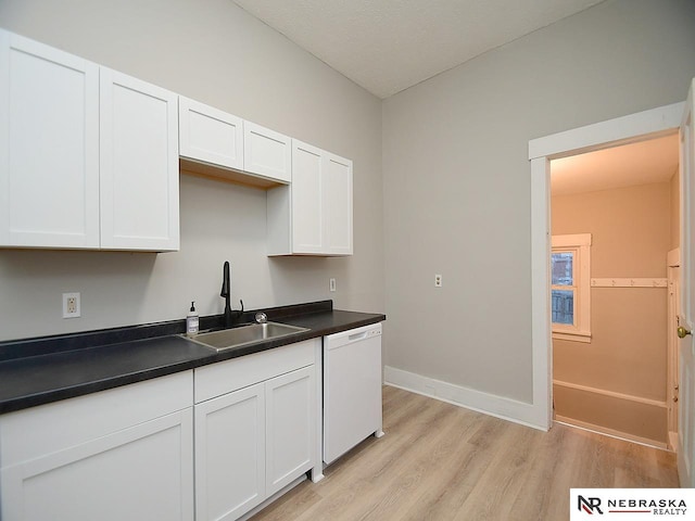 kitchen featuring white dishwasher, light hardwood / wood-style floors, sink, and white cabinets