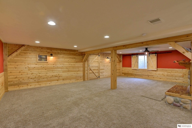 basement with carpet flooring and wooden walls