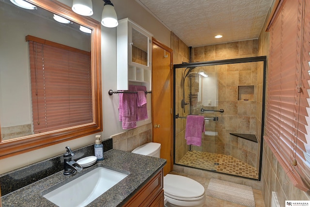 bathroom with vanity, toilet, and an enclosed shower