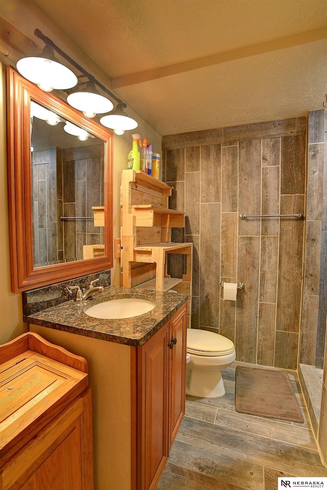 bathroom with vanity, toilet, and hardwood / wood-style floors