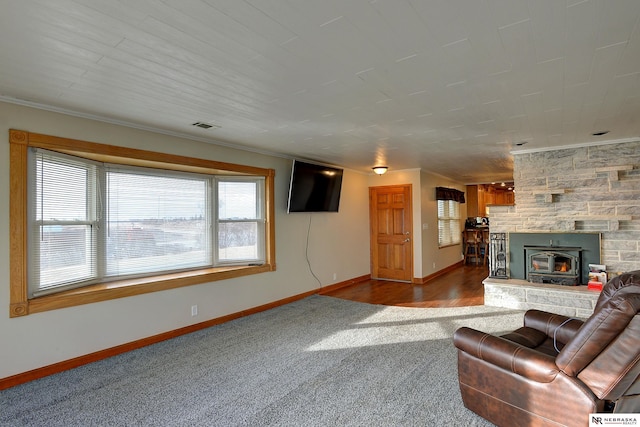 unfurnished living room with ornamental molding, a healthy amount of sunlight, and carpet flooring