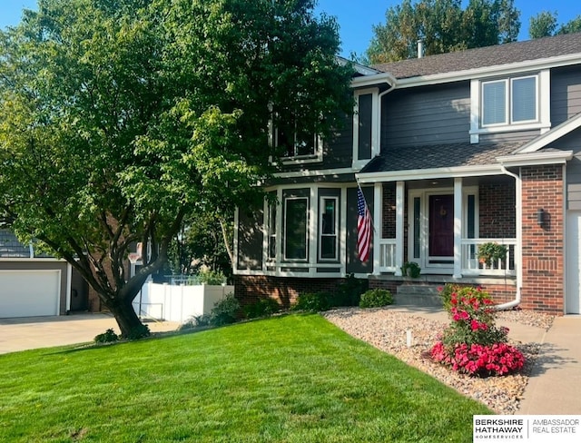 view of front of property featuring a garage and a front yard