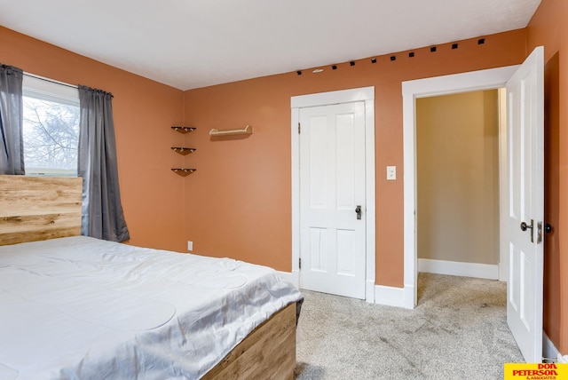 carpeted bedroom with a closet