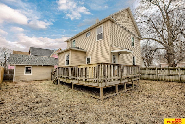 rear view of property featuring a wooden deck