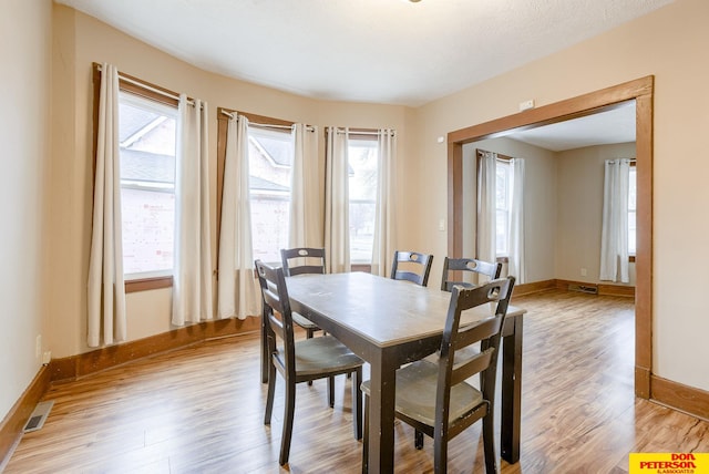 dining area featuring light hardwood / wood-style flooring and a wealth of natural light