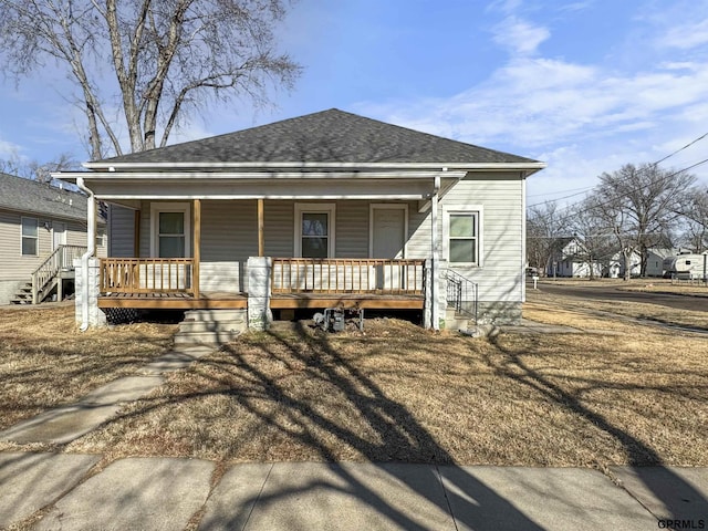 view of front of property featuring a porch and a shingled roof