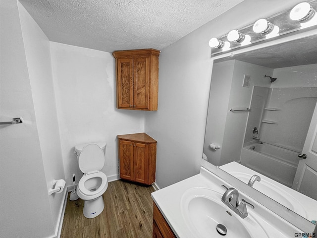 full bathroom with toilet, a textured ceiling, shower / tub combination, vanity, and hardwood / wood-style floors