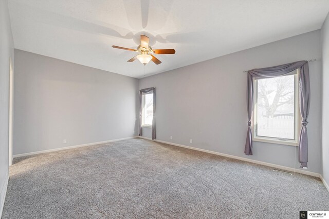 unfurnished room with ceiling fan and carpet flooring