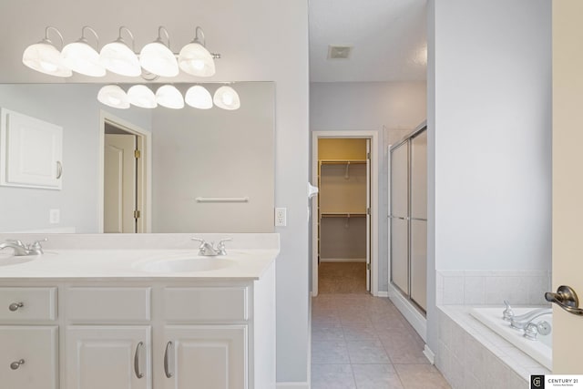 bathroom featuring independent shower and bath, vanity, and tile patterned floors