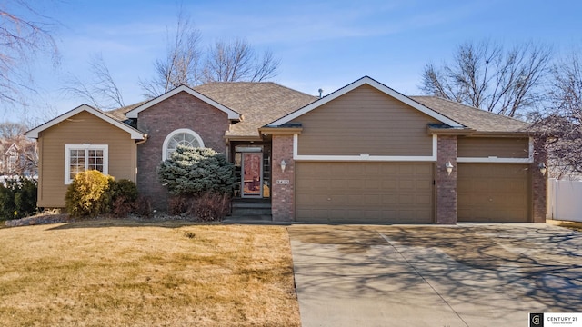 view of front of property with a garage and a front lawn