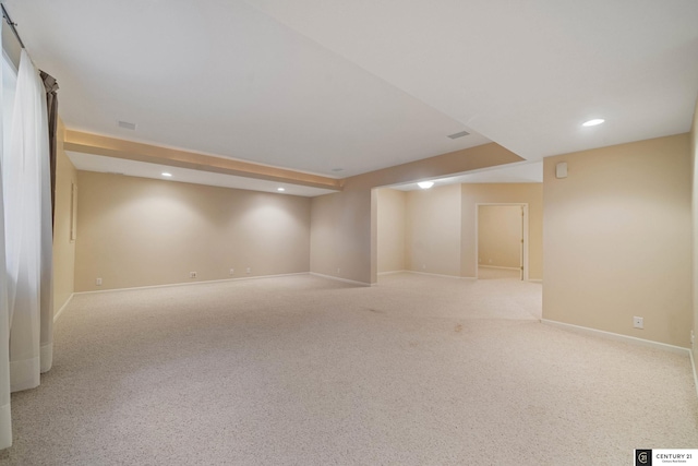 basement featuring light carpet