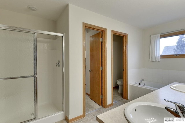 full bathroom featuring independent shower and bath, vanity, and toilet