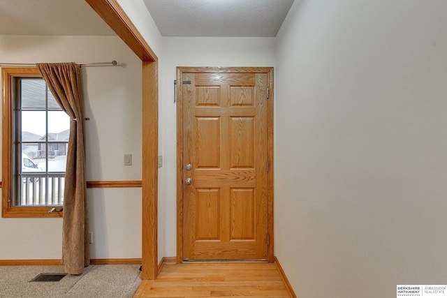 hall with light hardwood / wood-style flooring