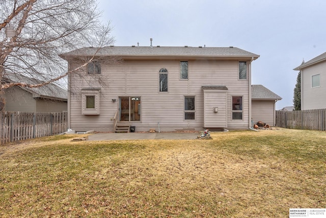 back of property featuring a yard and a patio