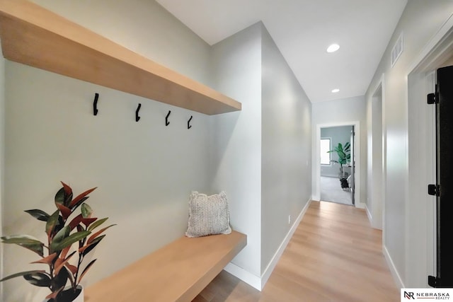 mudroom with light hardwood / wood-style floors