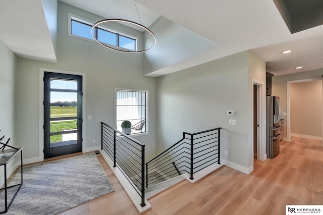 entryway with a high ceiling and light hardwood / wood-style flooring