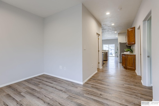 corridor with light hardwood / wood-style flooring