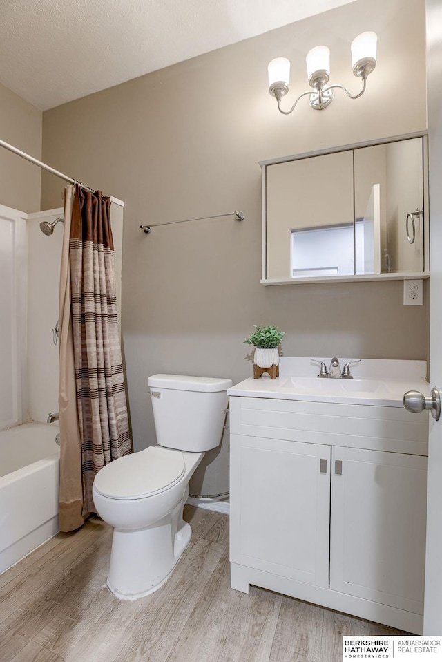 full bathroom with vanity, hardwood / wood-style floors, toilet, and shower / bath combo