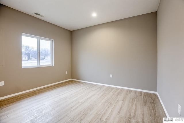 spare room featuring light hardwood / wood-style flooring