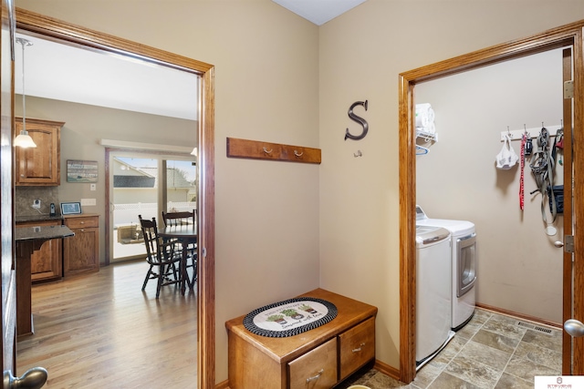 clothes washing area featuring washer and dryer