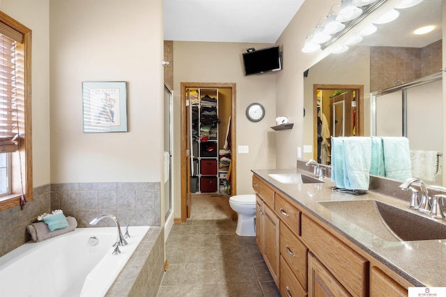 full bathroom featuring vanity, toilet, independent shower and bath, and tile patterned flooring