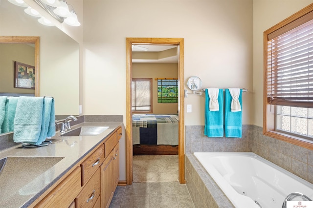 bathroom with vanity, tiled tub, and tile patterned flooring