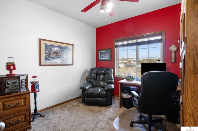 carpeted home office featuring ceiling fan