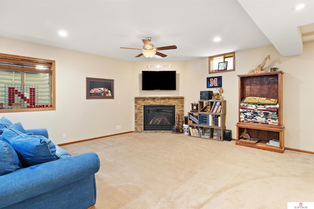 living room featuring ceiling fan and carpet