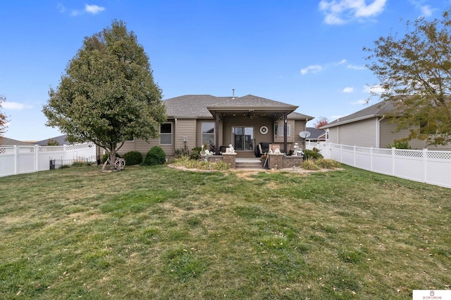 back of house with a yard, a patio area, and ceiling fan