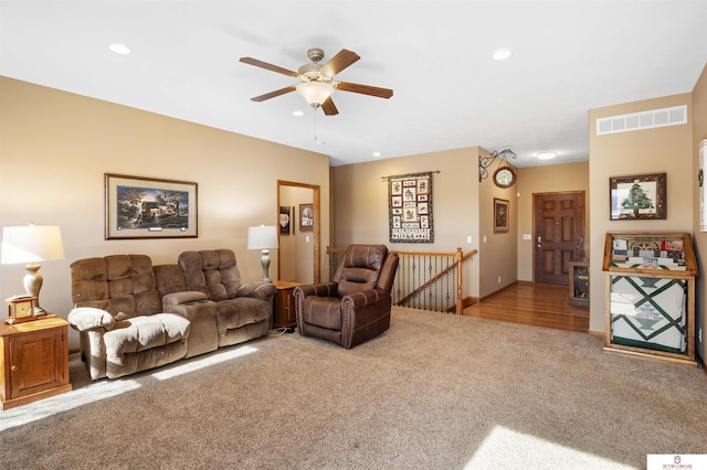 living room featuring ceiling fan and carpet