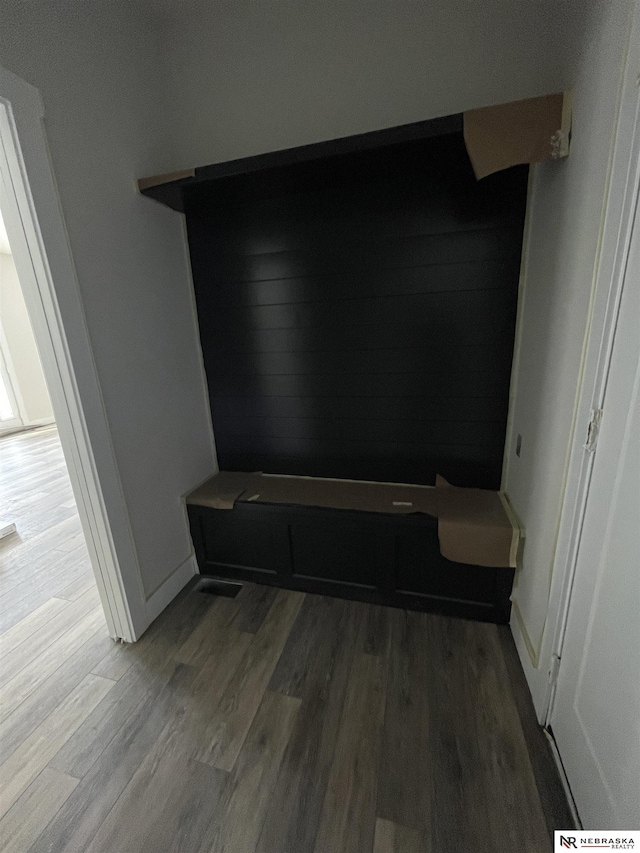 mudroom featuring wood finished floors and baseboards