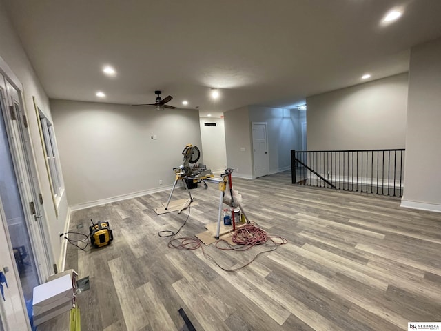 workout area with recessed lighting, baseboards, and wood finished floors