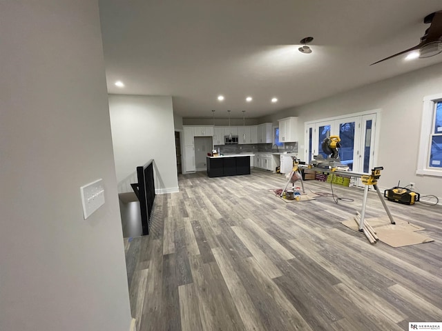 living room featuring recessed lighting, light wood-style floors, and a ceiling fan