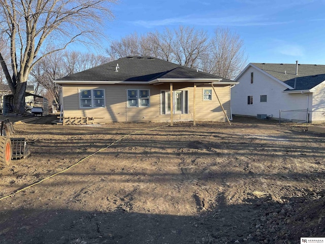 rear view of house with fence