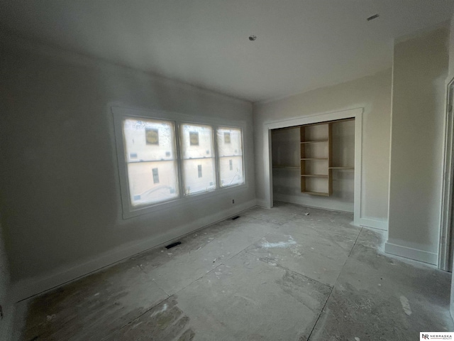 empty room featuring visible vents and baseboards