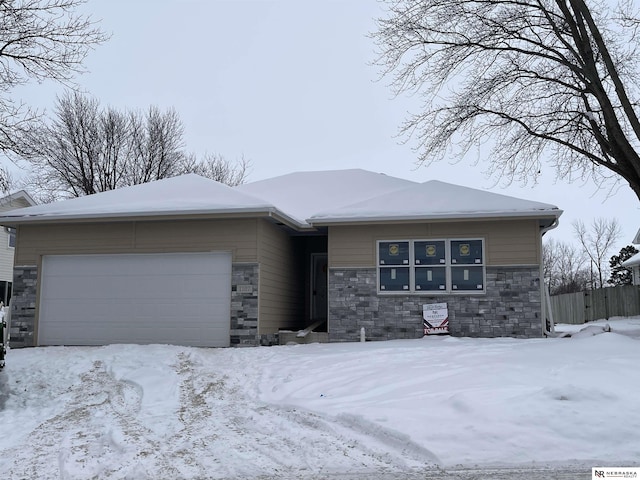 view of front facade with a garage and stone siding