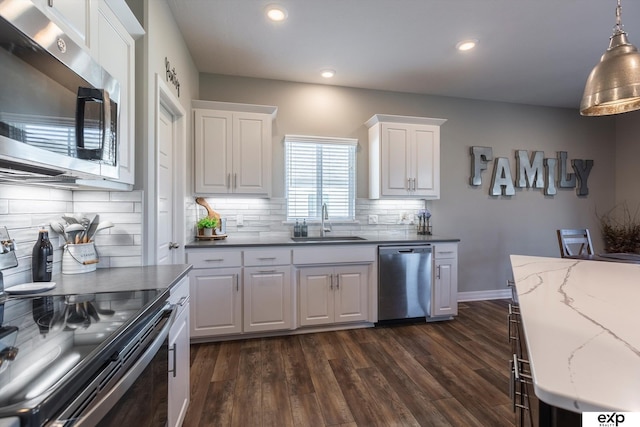 kitchen with stainless steel appliances, decorative light fixtures, sink, and white cabinets