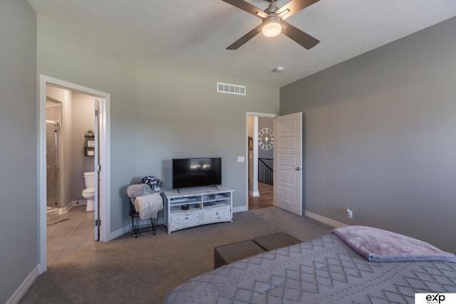 bedroom featuring ceiling fan, light colored carpet, and ensuite bathroom