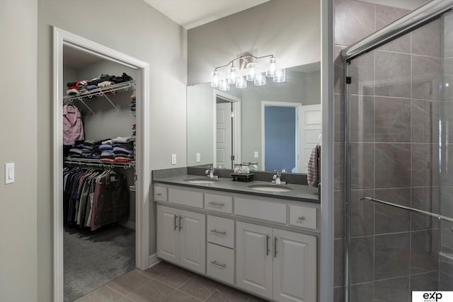 bathroom with vanity, tile patterned flooring, and a shower with door