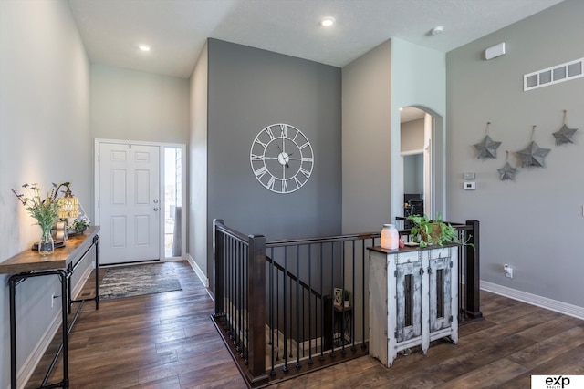 foyer entrance featuring dark wood-type flooring