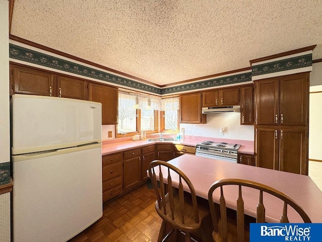 kitchen featuring crown molding, a textured ceiling, electric range, dark parquet floors, and white fridge