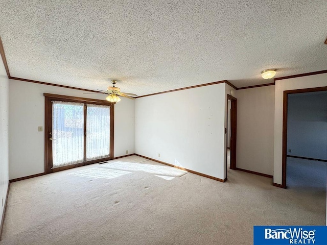 carpeted empty room with ceiling fan, ornamental molding, and a textured ceiling