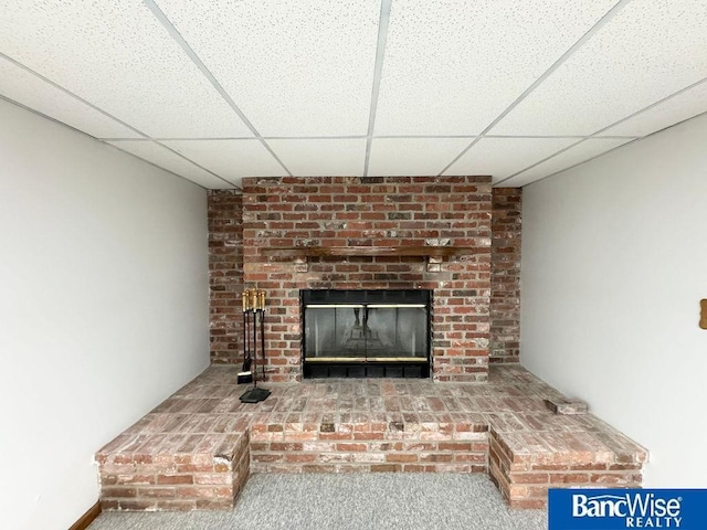 details with carpet floors, a fireplace, and a paneled ceiling