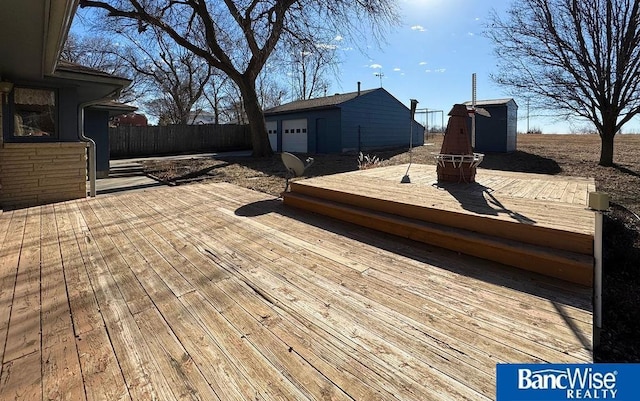 deck featuring an outbuilding and a garage