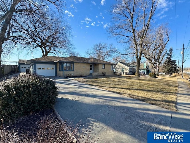 ranch-style home with a garage and a front yard