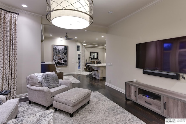 living room featuring crown molding, dark wood-type flooring, and ceiling fan