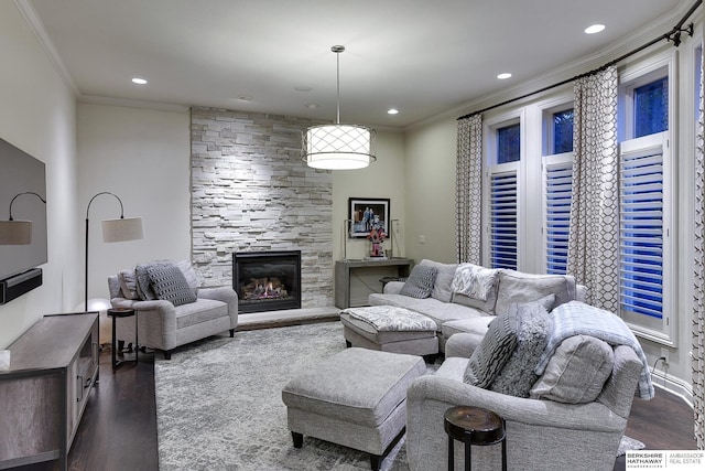 living room with dark wood-type flooring, a fireplace, and crown molding